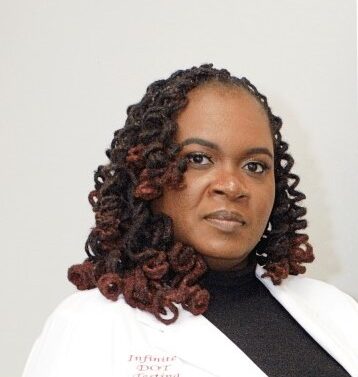 Black Female Entrepreneur dressed in beautiful white suit jacket with a black cashmere sweater on the inside